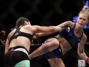 Holly Holm (right)) kicks Bethe Correia during UFC Fight Night at Singapore Indoor Stadium on June 17, 2017 in Singapore. (Suhaimi Abdullah/Getty Images)