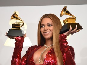 Singer Beyonce poses with her Grammy trophies in the press room during the 59th Annual Grammy music Awards on February 12, 2017, in Los Angeles, California. (ROBYN BECK/AFP/Getty Images)