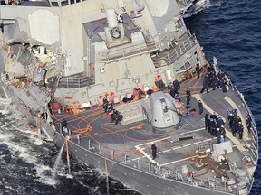 In this Saturday, June 17, 2017, photo, the damaged USS Fitzgerald is seen off Yokosuka, near Tokyo, Japan, after the Navy destroyer collided with a merchant ship. (Hitoshi Takano/Kyodo News via AP, File)