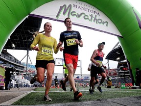 Manitoba Marathon participants cross the finish line at Investors Group Field in Winnipeg on Sun., June 18, 2017. Kevin King/Winnipeg Sun/Postmedia Network