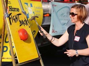 Luke Hendry/The Intelligencer
Breast cancer survivor Colleen Galway rings the starting bell during Friday’s Prince Edward County Relay for Life in Picton. The night's guest speaker, she said cancer forced her to find new strength and face her situation "head-on" rather than feel sorry for herself. This year’s relay raised nearly $40,000 for the Canadian Cancer Society.