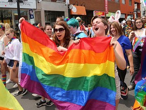 Haley Rideout, left, and Jane Ford sing and dance during the annual Kingston Pride Parade down Princess Street on Saturday. Approximately 1,000 people marched during the parade. (Ian MacAl;pine/The Whig-Standard/Postmedia Network