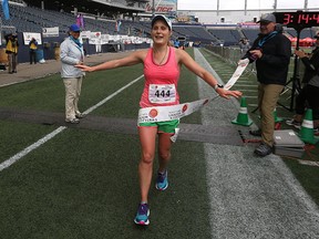 Manitoba Marathon female winner Emily Ratzlaff of Winnipeg crosses the finish line at Investors Group Field in Winnipeg on Sun., June 18, 2017. Kevin King/Winnipeg Sun/Postmedia Network