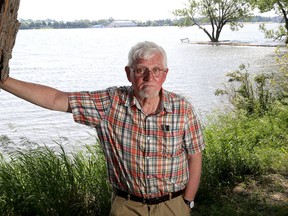 Maurice Smith, curator emeritus of the Marine Museum of the Great Lakes, is seen on the shore of the Cataraqui River on Sunday. (Ian MacAlpine/The Whig-Standard/Postmedia Network)