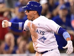 Toronto Blue Jays Ryan Goins celebrates his run-scoring triple to score teammate Steve Pearce against the Chicago White Sox during sixth inning American League baseball action in Toronto, Sunday, June 18, 2017. (THE CANADIAN PRESS/Frank Gunn)