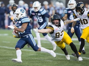 Hamilton Tiger-Cats defensive lineman Conner McGough fails to catch Toronto Argonauts running back Martese Jackson (30) during the first-half of CFL exhibition football action in Hamilton on Friday, June 16, 2017. (THE CANADIAN PRESS/Peter Power)