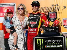 Kyle Larson, driver of the #42 Cars 3/Target Chevrolet, girlfriend, Katelyn Sweet, and son Owen, celebrate with the trophy in Victory Lane after winning the Monster Energy NASCAR Cup Series FireKeepers Casino 400 at Michigan International Speedway on June 18, 2017 in Brooklyn, Michigan. (Photo by Jonathan Ferrey/Getty Images)