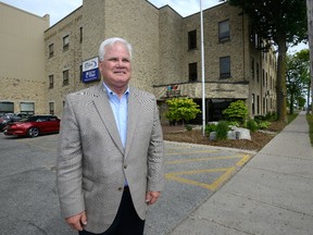 Hugh Mitchell, chief executive of Western Fair District, stands in front of the Rectory Street building that houses their main office, slated for demolition to make room for more Agriplex parking. (MORRIS LAMONT, The London Free Press)