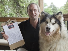 Cole Benjamin, seen here with his alaskan malamute "Marshall", has started a petition asking the city for a bylaw against keeping pets in hot vehicles in London. (DEREK RUTTAN, The London Free Press)