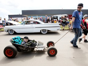 Joseph Baillargeon and his sons Baker Baillargeon, 1, and Caden Evans, 9, take in the 16th Annual Father's Day Show and Shine Car Show at Celebration Church, 7215 Argyll Road, Sunday June 18, 2017. Photo by David Bloom