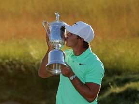 Brooks Koepka of the United States kisses the winner's trophy after his victory at the 2017 U.S. Open at Erin Hills on June 18, 2017 in Hartford, Wisconsin. (Photo by Streeter Lecka/Getty Images)