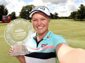Brooke Henderson of Canada imitates a selfie as she poses with the championship trophy during the final round of the Meijer LPGA Classic at Blythefield Country Club on June 18, 2017 in Grand Rapids, Michigan. (Photo by Stacy Revere/Getty Images)