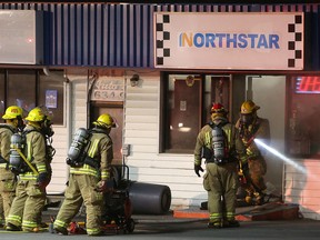 Kingston firefighters emerge from the Northstar gas station on Midland Avenue during a fire in Kingston, Ont. on Sunday, June 18, 2017
Elliot Ferguson/The Whig-Standard/Postmedia Network