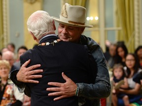 Tragically Hip singer Gord Downie hugs Governor General David Johnston after receiving the Order of Canada in Ottawa on Monday, June 19, 2017. Downie, who announced last year that he was diagnosed with terminal brain cancer, has become a strong advocate for indigenous people and issues. THE CANADIAN PRESS/Adrian Wyld