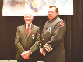 Retired Champion Fire Chief Doug Grant, left, stands with son Aaron. Both received the Exemplary Service medals for 20 years of fire service.
