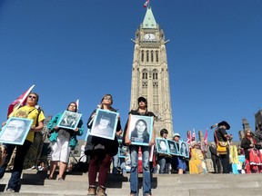 In this file photo, the faces of missing and murdered native women are lined up on the steps of Parliament Hill. Prime Minister Justin Trudeau, along with a number of his female cabinet ministers, made a surprise visit to a vigil for missing and murdered Indigenous women, girls and Two-Spirit people (MMIWG2S) Tuesday (Oct. 4, 2016) on Parliament Hill. Julie Oliver/Postmedia