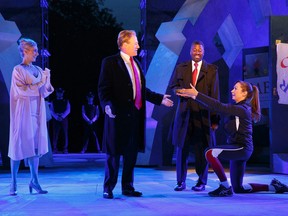 In this May 21, 2017 photo provided by The Public Theater, Tina Benko, left, portrays Melania Trump in the role of Caesar's wife, Calpurnia, and Gregg Henry, centre left, portrays President Donald Trump in the role of Julius Caesar during a dress rehearsal of The Public Theater's Free Shakespeare in the Park production of "Julius Caesar," in New York. Rounding out the cast on stage is Teagle F. Bougere as Casca, and Elizabeth Marvel, right, as Marc Anthony. (Joan Marcus/The Public Theater via AP)