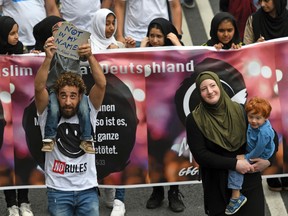 People attend a peace march of Muslims in Cologne, Germany, on Saturday, June 17, 2017. Hundreds of Muslims took part in the march to protest against terrorism in the name of Islam. (Henning Kaiser/dpa via AP)
