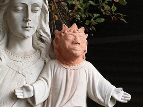 A statue is shown outside Ste. Anne des Pins parish in Sudbury, Ont., on Thursday Oct. 20, 2016. THE CANADIAN PRESS/Gino Donato