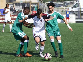 Ottawa Fury forward Sito Seoane fights for the ball with a couple of opponents last week. Caitie Ihrig Photo