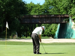 A golfer putts on the 10th hole at Kildonan Park Golf Course, which features an abandoned train bridge, on Mon., June 19, 2017. Winnipeg Golf Services expected to make $860,000 in revenues during 2016 but made $460,000 instead, the special operating agency confirmed. WGS now expects to pay back a line of credit to the city by 2025, instead of 2024. Kevin King/Winnipeg Sun/Postmedia Network