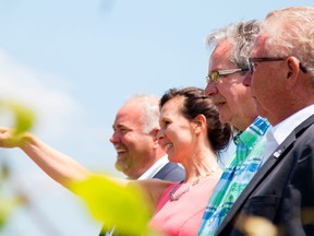 Taylor Bertelink/The Intelligencer
Catherine Langlois, owner of Sandbanks Winery gives the Minister of Agriculture, Jeff Leal (middle), a tour of the winery along with Prince Edward-Hastings MPP Todd Smith (left) and Prince Edward County mayor Robert Quaiff (right) on Tuesday after the Minister made his announcement.