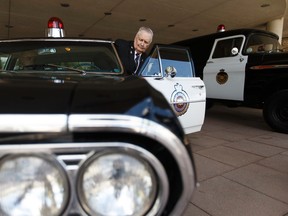 Retired police officer Ted Collinson gets into a restored 1964 Chevrolet Chevelle Malibu police car at the end of the Edmonton Police Service's official celebration of the 125th anniversary of the service's formation in 1892 at city hall in Edmonton, Alberta on Tuesday, June 20, 2017. (Ian Kucerak/Edmonton Sun)