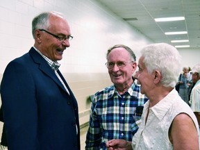 The Mitchell and District Community Centre was full over the noon-hour Tuesday as concerned community members, local and provincial politicians, residents, their family members and employees of Hillside Manor turned out for the first public meeting regarding the proposed closure of the long-term care home. Pictured, Darwin and Irma Lannin chat with Perth-Wellington MPP Randy Pettapiece after the meeting. (Galen Simmons/The Beacon Herald/Postmedia Network)