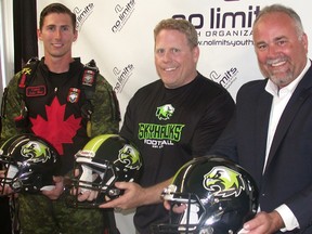 From left: Captain John Hart of the Canadian Armed Forces parachute team, Peter Gabriel of No Limits Youth Organization (NLYO) and Prince Edward Hastings MPP Todd Smith help officially launch the Quinte Skyhawks youth football team Tuesday night in Belleville. (Paul Svoboda/The Intelligencer)