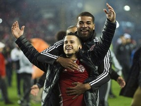 Toronto FC’s Sebastian Giovinco (left) reacts to the crowd after defeating the Montreal Impact during overtime MLS Eastern Conference final last fall. (The Canadian Press)