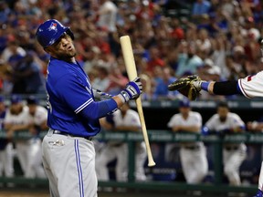 Blue Jays batter Steve Pearce (left) reacts after striking out with the bases loaded as Rangers catcher Jonathan Lucroy throws the ball back to pitcher Jose Leclerc during the seventh inning of MLB action in Arlington, Texas, on Tuesday, June 20, 2017. (AP Photo/Tony Gutierrez)