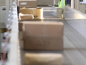 Mail goes through a sorting scanner at the main post office in Winnipeg on Dec. 15, 2014. (Brian Donogh/Postmedia Network/Files)