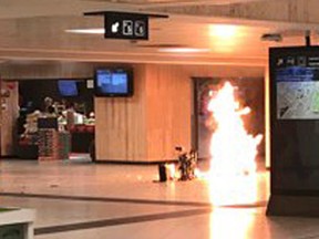 In this June 20, 2017 photo a man blows up an explosive device in the station in Brussels. The man was shot by soldiers afterwards in what prosecutors are treating as a "terrorist attack." He lay still for several hours while a bomb squad checked whether he was carrying more explosives and later died. No one else was hurt. (Remy Bonnaffe via AP)