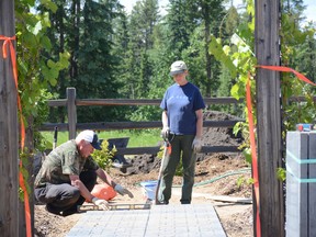 Wilbur (left) and Helen Schutte make sure a patio stone is level for a garden path outside the Forest Interpretive Centre on June 15. Helen Schutte will be judging for Whitecourt Communities in Bloom’s annual gardening competition (Peter Shokeir | Whitecourt Star).