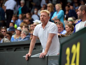 This file photo taken on July 12, 2015 shows German tennis coach Boris Becker standing in the players box on Centre Court as he watches the 2015 Wimbledon Championships at The All England Tennis Club. (Getty Images file photo)
