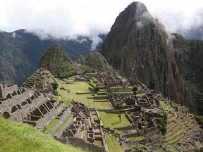 In this April 1, 2010 file photo, the citadel of Machu Picchu is seen during its reopening in Cuzco, Peru. Authorities said on Wednesday, June 21 2017, that tourist access to the fabled ruins has be reorganized into two shifts, to help conservations efforts. (AP Photo/Karel Navarro)