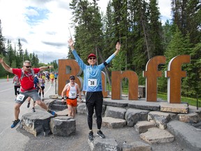 People running in the Banff Marathon ham it up in front of the new Banff entrance sign on Sunday, June 18, 2017. photo by Pam Doyle