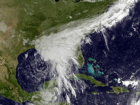 This satellite image taken Tuesday, June 20, 2017, and released by the National Oceanic and Atmospheric Administration shows a tropical storm over the Gulf of Mexico approaching the Gulf Coast. Tropical Storm Cindy hovered over the Gulf of Mexico south of Louisiana on Tuesday, churning tides and spinning bands of rain over the central and eastern Gulf Coast. (NOAA via AP)