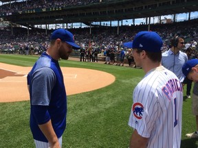 Nolan Patrick gets some last-minute pitching tips from Cubs reliever Justin Grimm. (Ted Wyman/Postmedia)