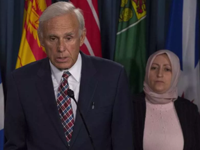 Rania Tfaily, Hassan Diab's wife, looks on as lawyer Donald Bayne responds to a question during a news conference in Ottawa, Wednesday June 21, 2017. ADRIAN WYLD / CP