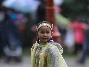Jordan wears a poncho in the rain during Aboriginal Day celebrations in Winnipeg. Wednesday, June 21, 2017. (Winnipeg Sun/Postmedia Network)