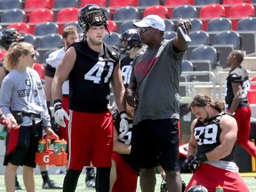 Defensive line coach Leroy Blugh (right) talks with DE Arnaud Gascon-Nadon during Ottawa Redblacks practice at TD Place Wednesday, June 21, 2017. (Julie Oliver/Postmedia)