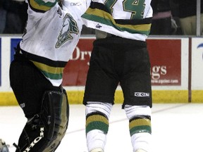 London Knights? goaltender Adam Dennis and Bryan Rodney celebrate after the Knights defeated the Rimouski Oceanic 4-0, in the Memorial Cup championship game May 29, 2005, at the John Labatt Centre in London.