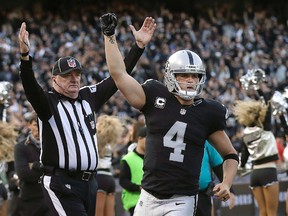 In this Nov. 27, 2016, file photo, Oakland Raiders quarterback Derek Carr (4) celebrates during a game against the Carolina Panthers in Oakland, Calif. (AP Photo/Marcio Jose Sanchez, File)