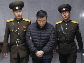 Canadian pastor Hyeon Soo Lim, centre, is escorted to his sentencing in Pyongyang, North Korea on Dec. 16, 2015. (AP Photo/Jon Chol Jin)
