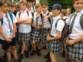 Screenshot of school boys in skirts. (Twitter screen grab, @simonhallnews)