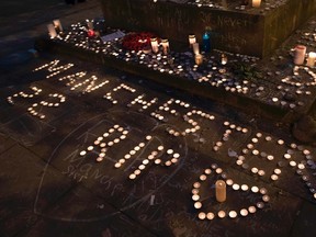 Memorial candles are seen during a vigil on St Ann's Square in Manchester, northwest England, on May 29, a week after a bomb attack at Manchester Arena killed 22 and injured dozens more. (Postmedia Network file photo)