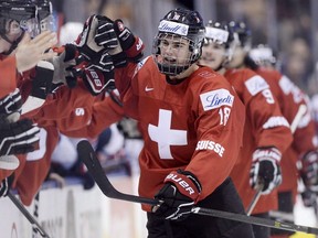 Switzerland forward Nico Hischier celebrates with teammates at the bench after scoring against the United States during IIHF World Junior Championship action in Toronto on Jan. 2, 2017. (THE CANADIAN PRESS/Frank Gunn)