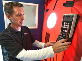 Kent Mohn, VP operations at Sun Ridge, an energy advisors company, demonstrating a pressurized blower door testing for airtightness after the launch of a voluntary EnerGuide for Homes, a new city program aimed at helping homeowners reduce their energy use in Edmonton, June 22, 2017.