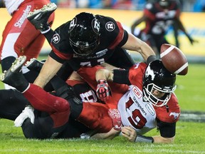 The Redblacks pass rush got to Calgary Stampeders quarterback Bo Levi Mitchell several times during the Grey Cup. (THE CANADIAN PRESS)